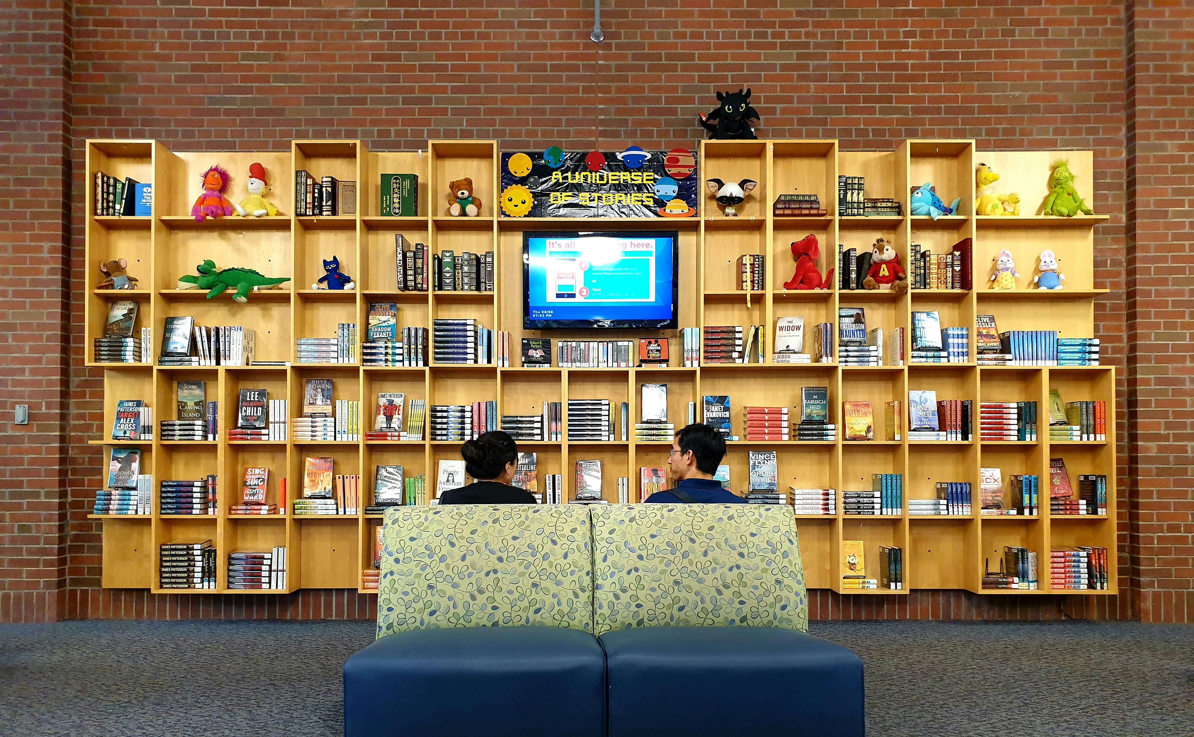 Teachers sitting on couch watching a lesson